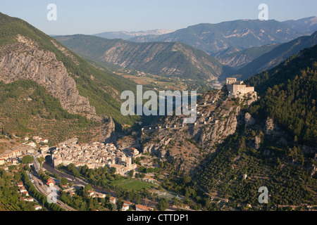 AERIAL VIEW. The citadel of Entrevaux dominated by its castle on a strategically narrow passage in the Var Valley, Alpes-de-Haute-Provence, France. Stock Photo