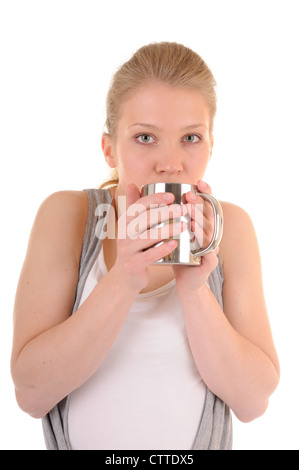 Casual blond girl is drinking from metal cup, isolated on white background Stock Photo
