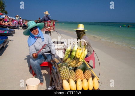 Vendors selling fruit at Chaweng beach and the Gulf of Thailand on the island of Ko Samui, Thailand. Stock Photo