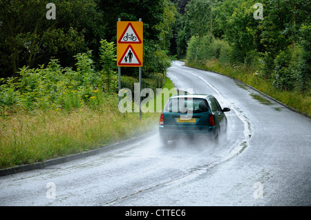 driving in the wet on country lane Stock Photo