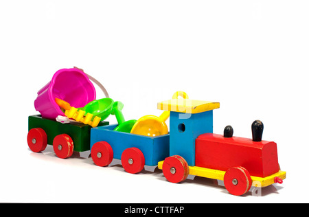 wooden red and yellow train to the beach with toys Stock Photo