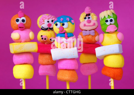 multi colored marshmallow lollipops on a pink background Stock Photo