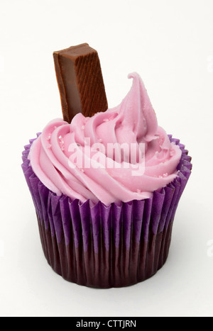 Cupcake with pink icing and chocolate finger against a white background Stock Photo