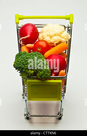 miniature shopping cart full of vegetables Stock Photo