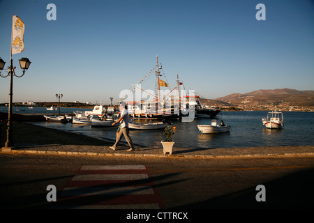 A man walks in the picturesque port of Antiparos during the sunset. Stock Photo
