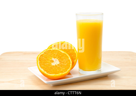 Freshly squeezed orange juice with an orange that has been cut in half - studio shot with a plain white background Stock Photo