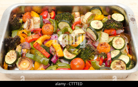 An assortment of roasted vegetables on a baking tray- studio shot Stock Photo