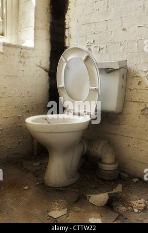 Broken old abandoned dirty toilet bowl Stock Photo