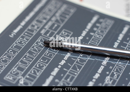 pda stylus on handwriting guide Stock Photo