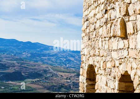 stone wall of Kerak castle and view on mountain valley, Jordan