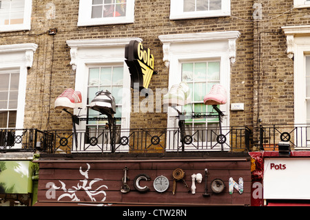 Larger than life models of shoes on the facade of a shop in Camden. Stock Photo