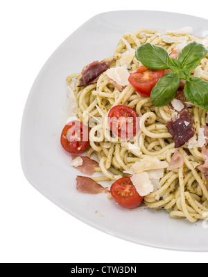 Plate with Spaghetti and Pesto Sauce isolated on white Stock Photo