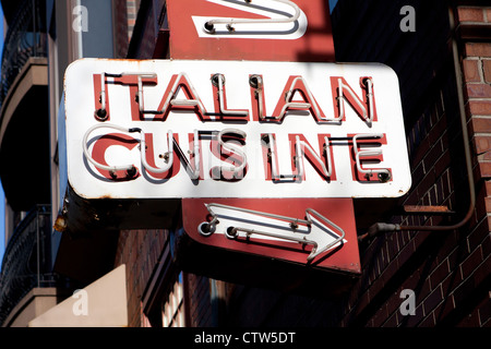 An old neon sign that reads ITALIAN CUISINE in glass tubing. Stock Photo