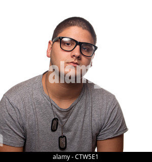 A young teenage man isolated over white wearing black frame nerd type vintage glasses and military style dog tags. Stock Photo