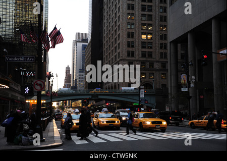 Dawn 'urban alley' view taxis waiting, people crossing East 42nd Street at Vanderbilt Avenue, Grand Central Station, New York Stock Photo