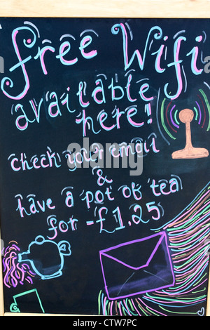 Free Wifi sign on chalkboard outside cafe with drawings of teapot and envelope and price for pot of tea Wales UK Stock Photo