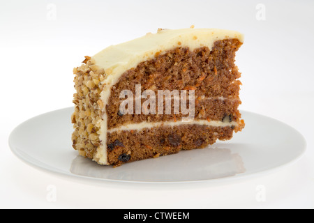 Slice of Carrot Cake on a white plate - brightly lit with a shallow depth of field Stock Photo