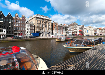 sightseeing boats in typical amsterdam canal Stock Photo