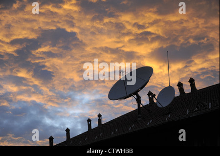 parabolic antennas for the reception of the satellite televisions on the roofs Stock Photo