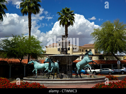 Herd wild horses water fountain art sculpture traffic circle roundabout Old Town Scottsdale AZ Stock Photo