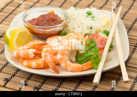 King prawn and fried rice served with a salad and a chilli and tomato dip - studio shot Stock Photo