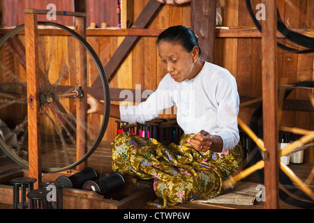 The weaving of LOTUS SILK fabric from the stalks of the lotus plant is a local industry of INLE LAKE - MYANMAR Stock Photo