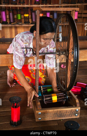 The weaving of LOTUS SILK fabric from the stalks of the lotus plant is a local industry of INLE LAKE - MYANMAR Stock Photo