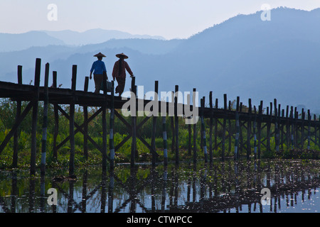 BURMESE use the raised walkway near the village of MAING THAUK on the way to the weekly market - INLE LAKE, MYANMAR Stock Photo