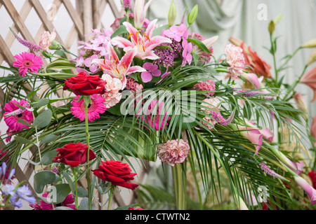 a floral display using roses,gerbera,lilies,palm leaves,hebe,hydrangea and a callo lily Stock Photo