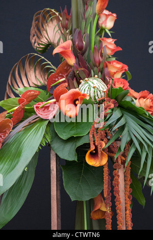 a floral display using calla,lily,roses proteus and tropical foliage Stock Photo