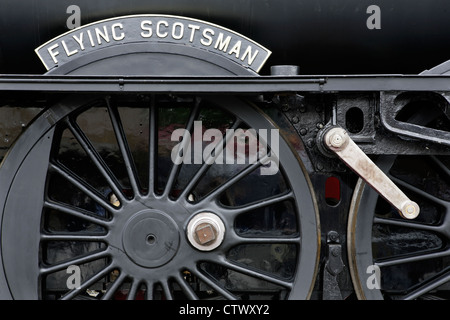 Nameplate and driving wheels of  LNER steam locomotive Flying Scotsman during restoration. Stock Photo
