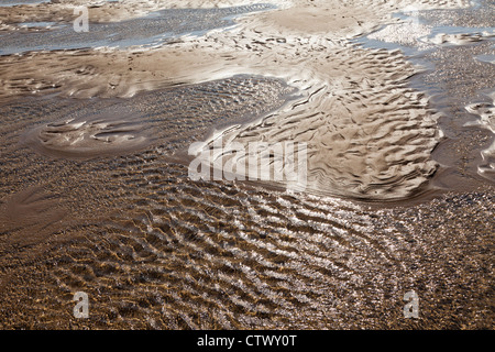 Sand patterns and the incoming tide at Bantham, Devon Stock Photo