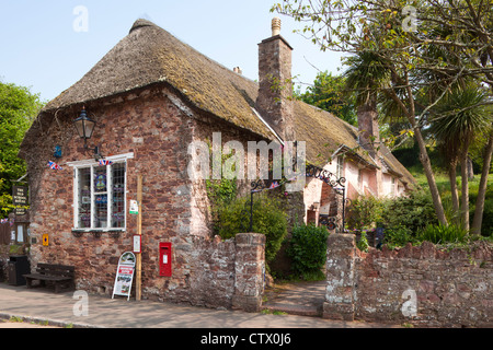 The thatched old school house (now a gift shop) in the village of Cockington, Devon Stock Photo