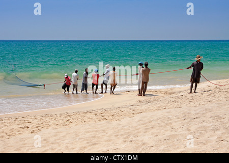 Fishermen pulling in large net (madela), south coast of Sri Lanka Stock Photo