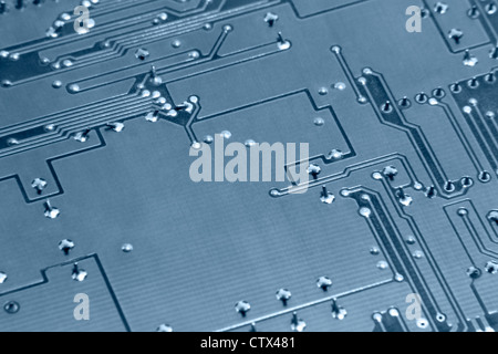 blue toned abstract detail of a circuit board backside Stock Photo