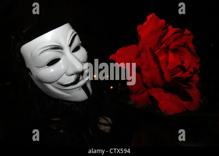 An Israeli protester wears a Guy Fawkes mask used by the anonymous movement takes part in the Cost of Living protest in Tel Aviv Israel. The Guy Fawkes mask is a well-known symbol for the online hacktivist group Anonymous used in anti-government and anti-establishment protests around the world. Stock Photo