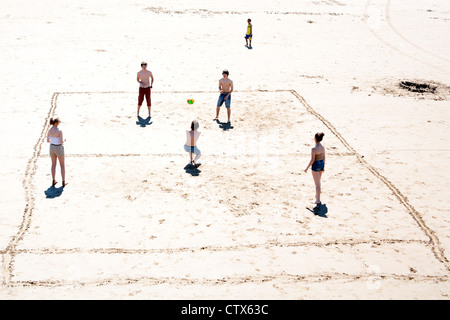 Young people playing volley ball on the beach at Weston Super Mare Somerset United Kingdom Stock Photo