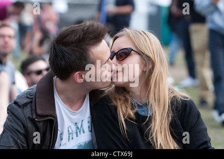 A couple kissing in the audience at Lovebox festival, Victoria Park, London June 2012 Stock Photo