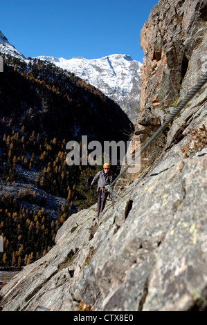 Climber on La Resgia, a via ferrata in Pontresina, Engadin St. Moritz, Switzerland Stock Photo
