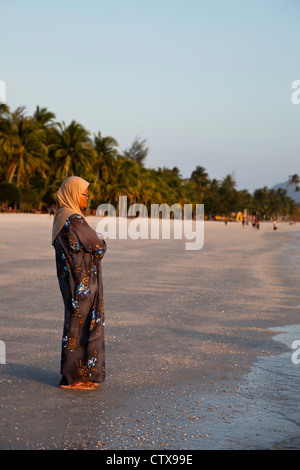 Muslim woman on Pantai Cenang Beach Pulau Langkawi Malaysia. Stock Photo