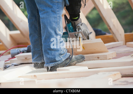 Carpenter using a circular saw Stock Photo