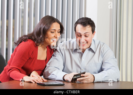 Business couple using tablet and smartphone Stock Photo