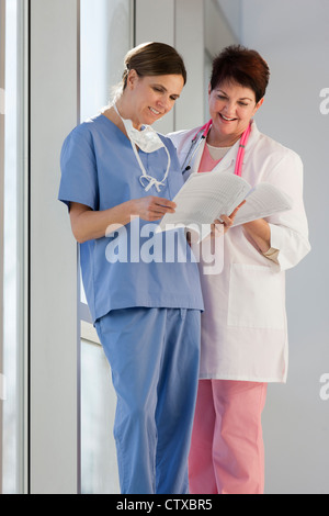 Two nurses looking at patient records Stock Photo