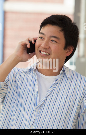 Chinese man talking on his cell phone Stock Photo