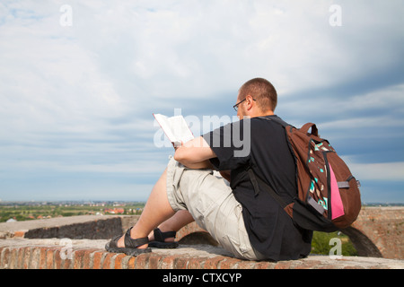 Young man sitting outdoors and meditating Stock Photo