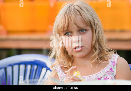 Portrait of a little blond beautiful Russian girl above bright outdoor background Stock Photo