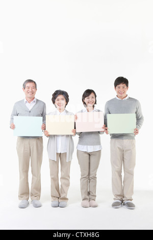 Grandparents and parents with colorful board Stock Photo