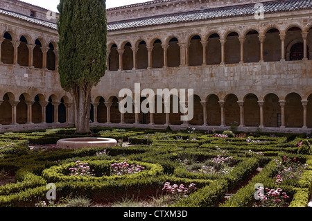 Romanesque cloister of the Benedictine Abbey of Silos and the garden with its famous cypress planted in 1882, Santo Domingo Monastery, Burgos, Spain, Stock Photo