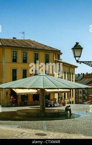 overed with a huge umbrella so that the milkmaids could protect themselves at the beginning of the 20th century in the city of Oviedo, Asturias, Spain Stock Photo