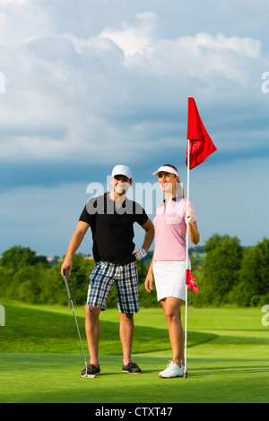 Young golf player on course putting Stock Photo